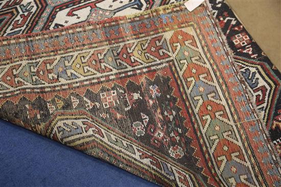 An antique Caucasian polychrome ground rug, 7ft 5in by 4ft 4in.